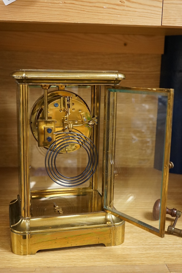 A four glass and brass mantel clock, 25cm high, 17cm wide.